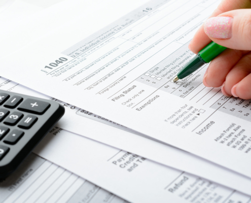 Female Hands And Tax Form