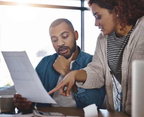 Two Office Workers Looking Through Paperwork
