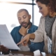 Two Office Workers Looking Through Paperwork