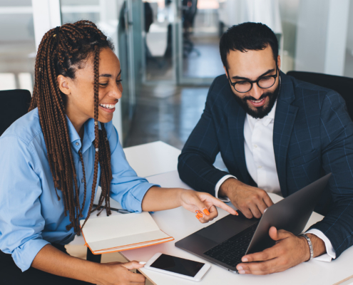 Business People Loooking At Laptop In Office Space
